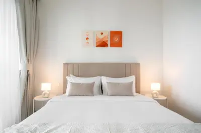 a bedroom with a large white bed with two lamps at Peaceful Dunes 1 - Burj Khalifa & Dubai Mall in Dubai