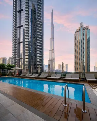 a pool in the middle of a city with tall buildings at Peaceful Dunes 2 - Near Burj Khalifa & Dubai Mall in Dubai