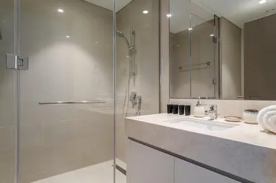 a bathroom with a glass shower and a sink at Peaceful Dunes 2 - Near Burj Khalifa & Dubai Mall in Dubai