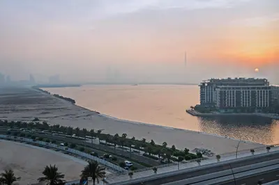 a view of a hotel on the beach with the ocean at Elegant 2-Bedroom Apartment in Dubai Creek Harbour - By Dustay in Dubai