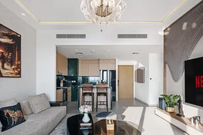 a living room with a couch and a table at Elegant 2-Bedroom Apartment in Dubai Creek Harbour - By Dustay in Dubai