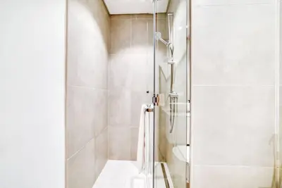 a shower with a glass door in a bathroom at 5 Mins to JBR Beach, Luxury Studio in Dubai Marina's Best Tower in Dubai