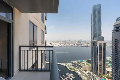 a balcony of a building with a view of the water at Skyline Huge 1 Bedroom Apartment Creek in Dubai