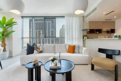 a living room with a white couch and some tables at Skyline Huge 1 Bedroom Apartment Creek in Dubai
