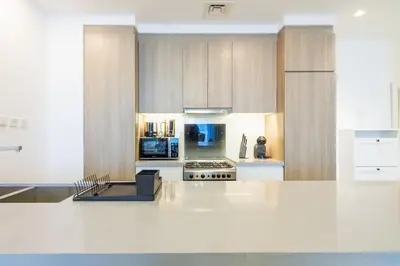 a kitchen with a white counter top and a stove top oven at Stella Maris, Dubai Marina- Luxurious 1-BR in Dubai