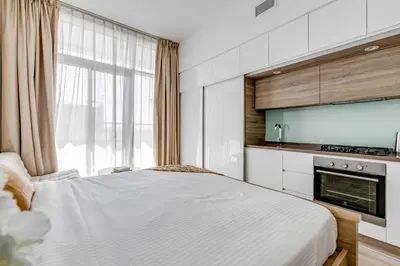 a bedroom with a white bed and a large window at Knokey Dubai Marina Comfortable Apartments with Pool and Gym in Dubai