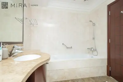 a bathroom with a sink and a bath tub at Mira Holiday Homes - Spacious 2 bedroom with patio in Palm Jumeirah in Dubai