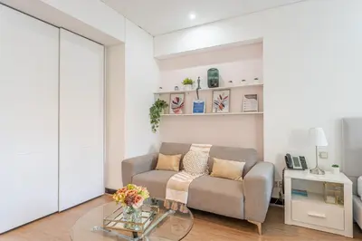 a living room with a couch and a glass table at HAVN - Studio Dubai Marina View in Dubai