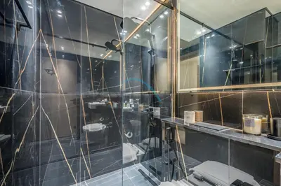 a bathroom with a shower with a glass wall at Cozy 1BR at Binghatti Corner, Jumeirah Village Circle by Deluxe Holiday Homes in Dubai