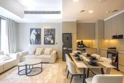 a kitchen and living room with a table and chairs at Mag Eye Townhouse - 2BR & M Room Townhouse - Allsopp & Allsopp in Dubai