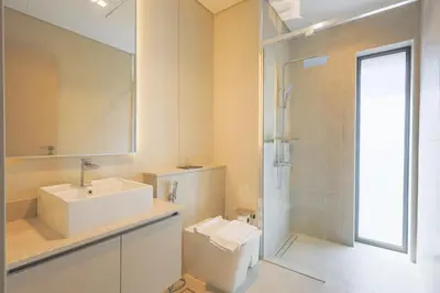 a bathroom with a toilet and a sink and a shower at Mag Eye Townhouse - 2BR & M Room Townhouse - Allsopp & Allsopp in Dubai