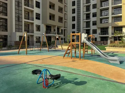 an empty playground in front of a apartment building at Frank Porter - Parkside Rawda 4 in Dubai