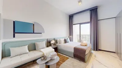 a hotel room with a bed and a couch at Mag Eye 910 - Aesthetic Studio Apartment in Meydan in Dubai