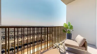 a balcony with a chair and a view of a city at Mag Eye 910 - Aesthetic Studio Apartment in Meydan in Dubai