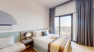 a hotel room with a bed and a large window at Mag Eye 920 - Classy Studio Apartment in Meydan in Dubai