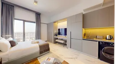 a hotel room with a bed and a television at Vacationer I Stylish Studio I Skyline & Community Views I 12 Mins to Downtown I MAG Eye 910 in Dubai