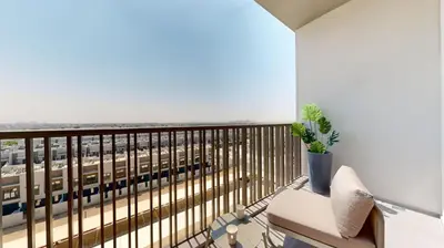 a balcony with a view of a train at Vacationer I Stylish Studio I Skyline & Community Views I 12 Mins to Downtown I MAG Eye 910 in Dubai