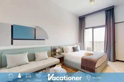 a hotel room with a bed and a couch at Mag Eye 910 - Peaceful Studio Apartment in Meydan in Dubai