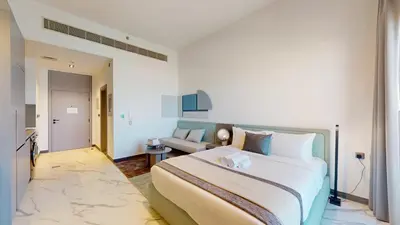 a bedroom with a large bed and a couch at Mag Eye 930 - Calm Studio Apartment in Meydan in Dubai