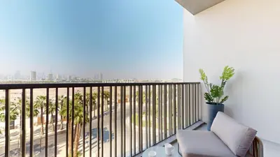 a balcony with a chair and a view of the city at Mag Eye 930 - Calm Studio Apartment in Meydan in Dubai