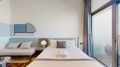 a bedroom with a bed and a couch at Mag Eye 930 - Calm Studio Apartment in Meydan in Dubai