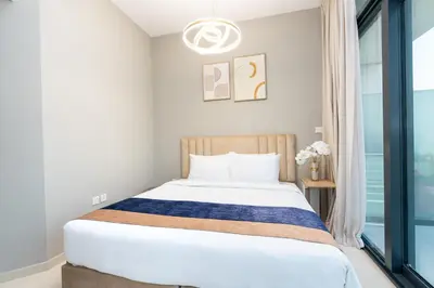 a bedroom with a bed and a window at Citihome - 1BR with Huge Balcony & Easy Transport Access in Dubai