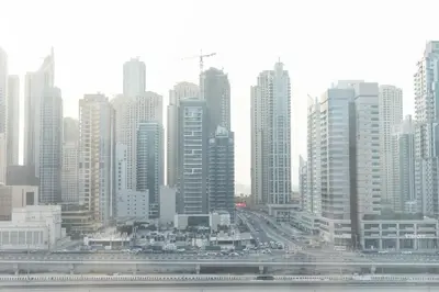 a city skyline with tall buildings and a freeway at Handsome 1BR in Armada Tower 3 in Dubai