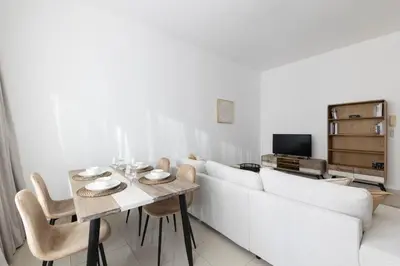 a living room with a white couch and a table at Handsome 1BR in Armada Tower 3 in Dubai