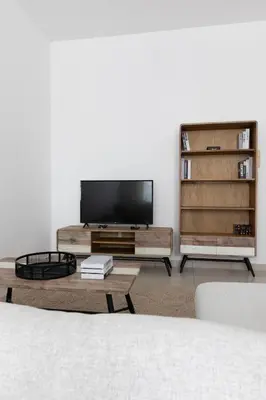 a living room with a flat screen tv and a coffee table at Handsome 1BR in Armada Tower 3 in Dubai