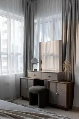 a bedroom with a dresser with a television on it at Handsome 1BR in Armada Tower 3 in Dubai