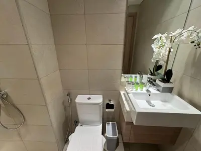 a bathroom with a white toilet and a sink at Ashri Elegant Studio Near Burj Khalifa in Dubai