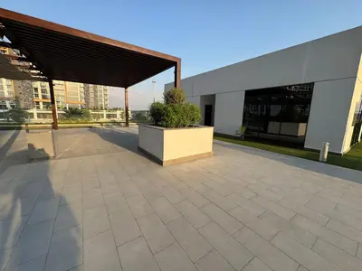 a building with a large patio with a potted plant at Ashri Elegant Studio Near Burj Khalifa in Dubai