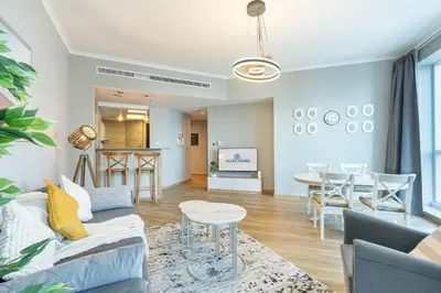 a living room with a couch and a table at Cozy Home at the Heart of Marina on 52nd Floor in Dubai