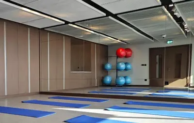 a yoga room with blue mats on the floor at White Sage Sun and Sand 1BR at Beach Isle Emaar BeachFront in Dubai