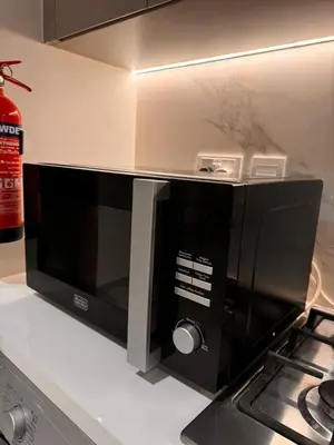 a microwave oven sitting on a counter in a kitchen at Burj Khalifa view modern 1BHK with balcony in Dubai