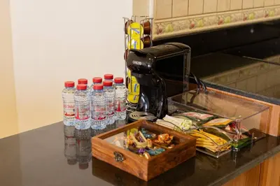 a table with bottles of water and a sewing machine at Lux two br w Sea Views from rooms in Dubai Marina in Dubai