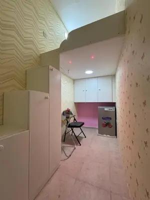 a room with a kitchen with a table and a refrigerator at Loft bed short and long stay in Dubai