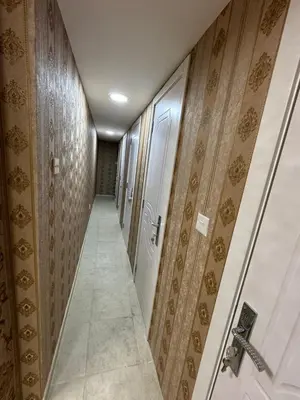 a corridor with wooden walls and a hallway with doors at Loft bed short and long stay in Dubai
