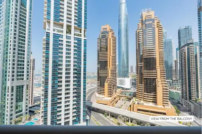 a view of a city with many tall buildings at Ultra-Chic 1BR Near Marina & Beach Walk in Dubai