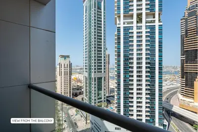 a view of a city from the balcony of a building at Ultra-Chic 1BR Near Marina & Beach Walk in Dubai
