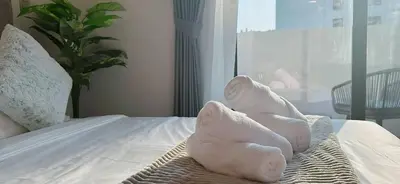 two towel animals sitting on top of a bed at Elegant Studio Apartment In Meydan One in Dubai