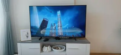 a flat screen tv sitting on top of a white cabinet at Elegant Studio Apartment In Meydan One in Dubai