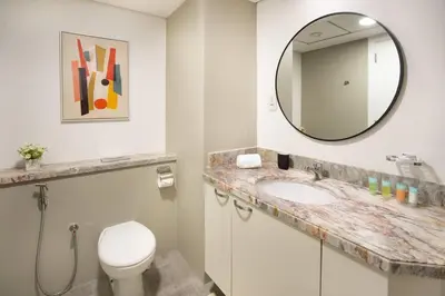 a bathroom with a sink and a mirror at Prime retreats - steps to Grosvenor Hotel in Dubai