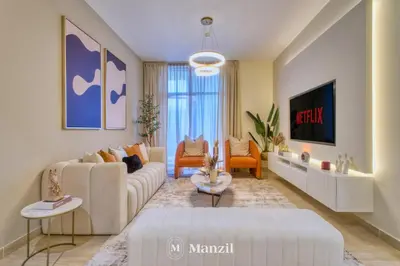 a living room with a couch and a tv at 2BR Apt in Business Bay with Iconic Burj Khalifa and Dubai Canal Views in Dubai