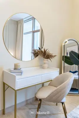a white desk with a mirror and a chair at 2BR Apt in Business Bay with Iconic Burj Khalifa and Dubai Canal Views in Dubai