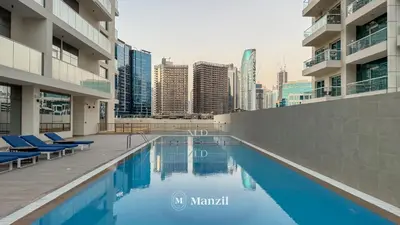 a swimming pool in the middle of a city at 2BR Apt in Business Bay with Iconic Burj Khalifa and Dubai Canal Views in Dubai