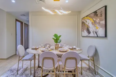 a dining room with a table and chairs at 2BR Apt in Business Bay with Iconic Burj Khalifa and Dubai Canal Views in Dubai