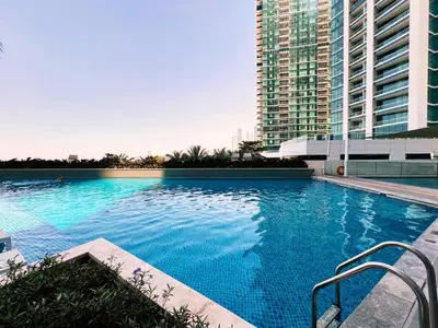 a large blue swimming pool with a tall building at Address JBR, Beach View, Jumeirah Beach Residence - Mint Stay in Dubai