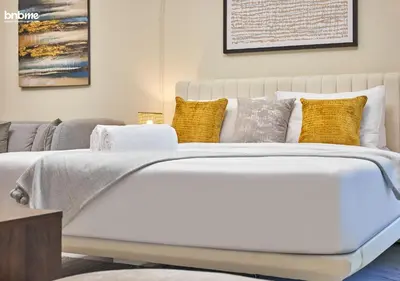 a bedroom with a white bed with pillows at bnbmehomes - Serenity Lakes 5 in Dubai