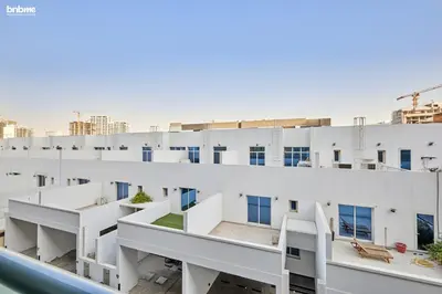 an image of a white apartment building with balconies at bnbmehomes - Serenity Lakes 5 in Dubai
